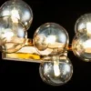 Casa Padrino Designer Wandleuchte Gold / Bernsteinfarben 66 x 23 x H. 24 cm - Moderne Wohnzimmer Lampe
