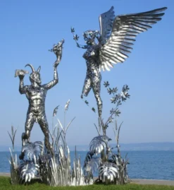 Casa Padrino Luxus Deko Skulptur Engel und Pan Silber 325 x 173 x H. 370 cm - Riesige Edelstahl Skulptur - Riesige Garten Deko Figur - Garten Skulpturen - Metall Skulpturen