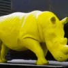 Casa Padrino XXL Deko Skulptur Nashorn Gelb 340 cm - Lebensgroße Garten Figur